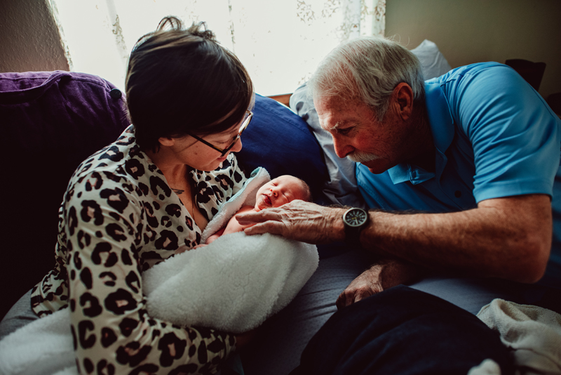Postpartum Photography - grandmother and grandfather admire newborn grandchild